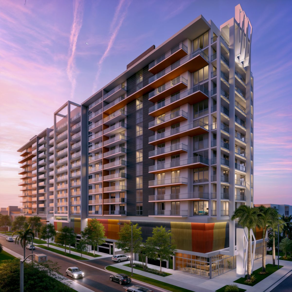 Dusk view of a thirteen-story apartment tower, balconies lit and crown signage above.