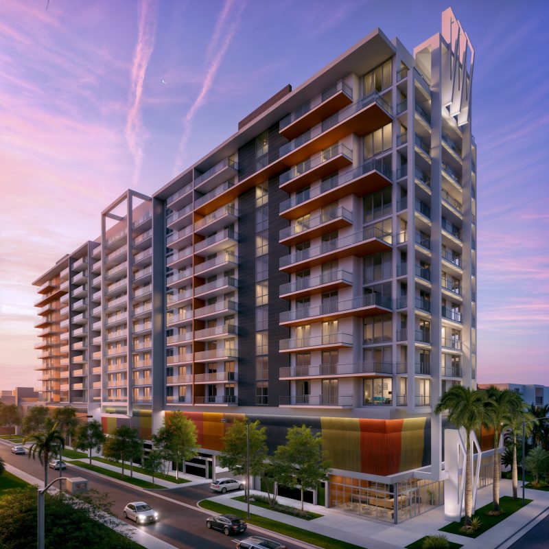 Dusk view of a thirteen-story apartment tower, balconies lit and crown signage above.