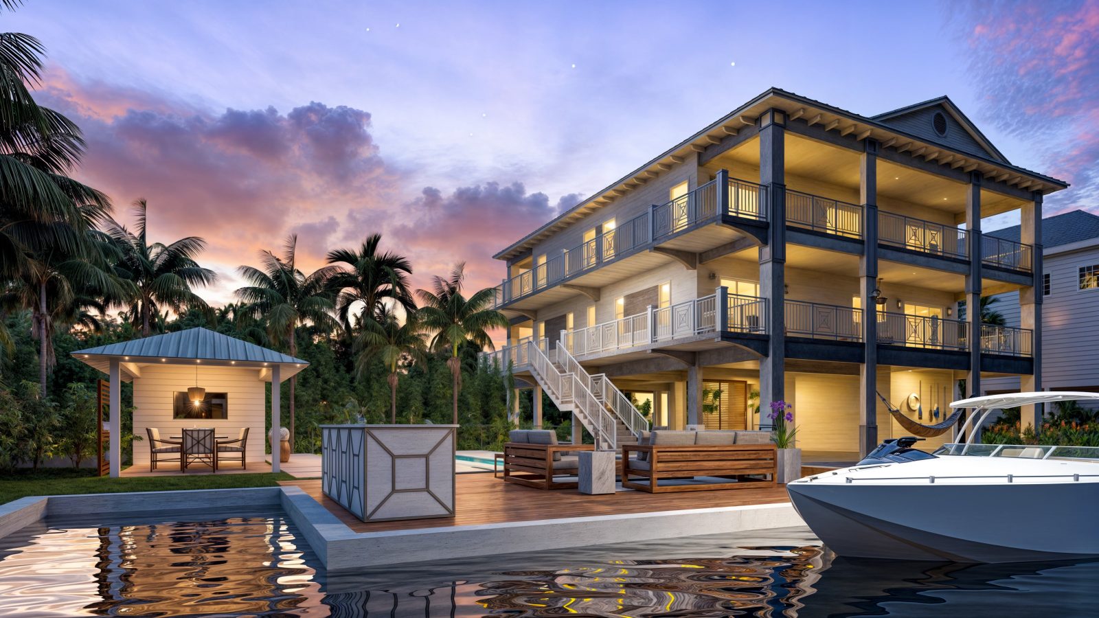 Three-story stilted coastal residence at dusk, with a dock, cabana and boat lift on the canal.