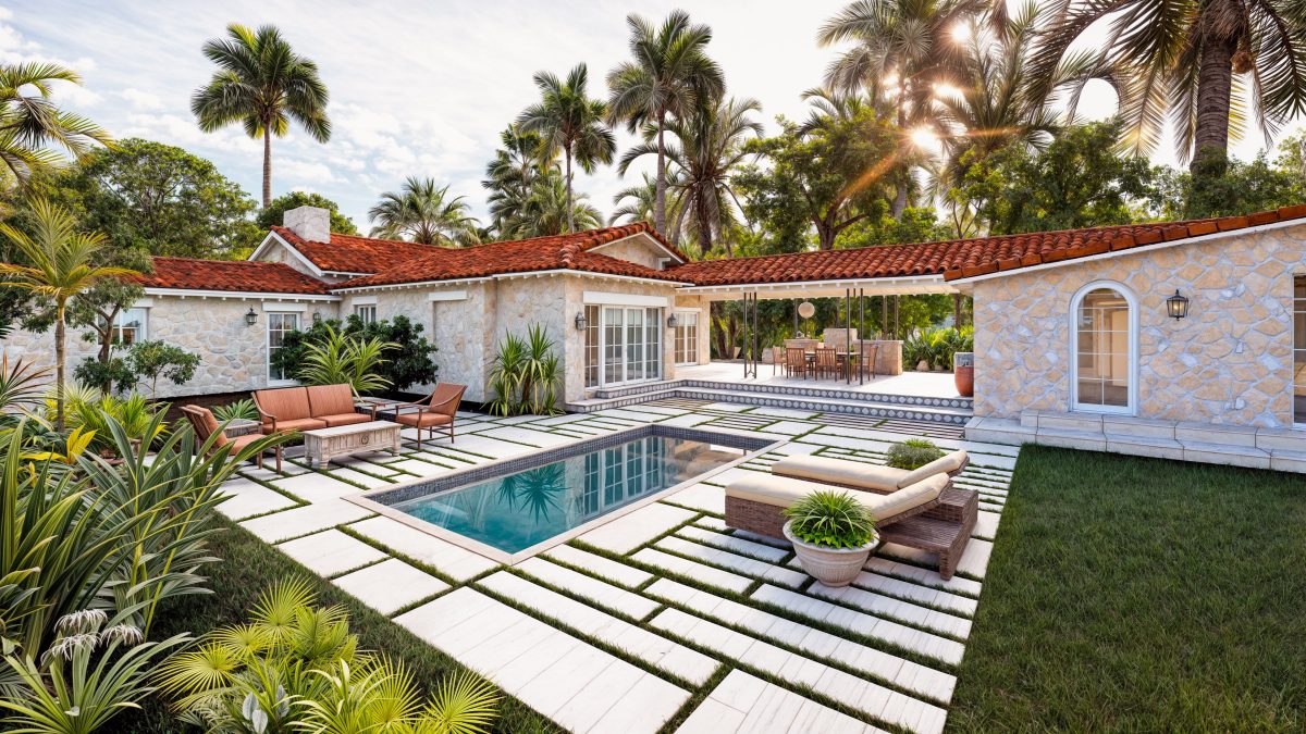 Pool courtyard at golden hour, framed by the residence's stone wings and palms.