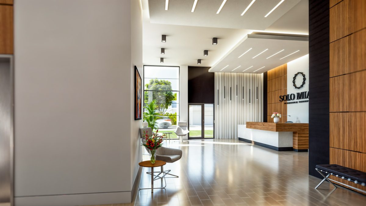Lobby toward the reception desk, with a slatted screen wall and street-front glazing.