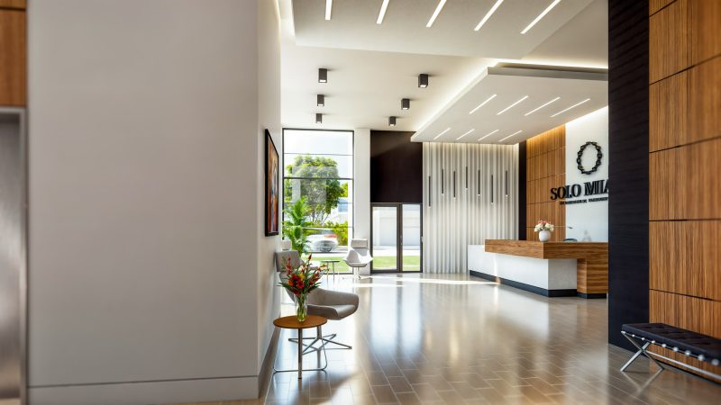 Lobby toward the reception desk, with a slatted screen wall and street-front glazing.